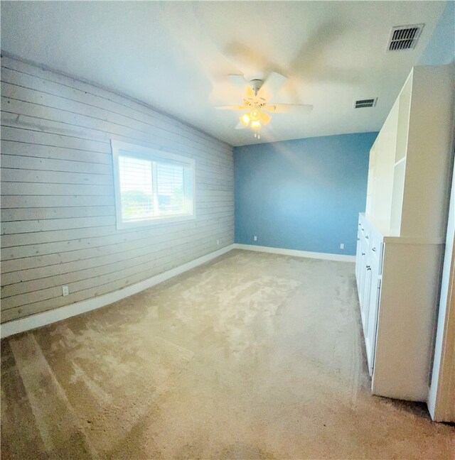 carpeted empty room with ceiling fan