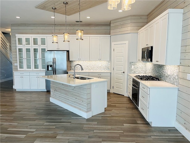 kitchen featuring stainless steel appliances, white cabinetry, sink, and pendant lighting