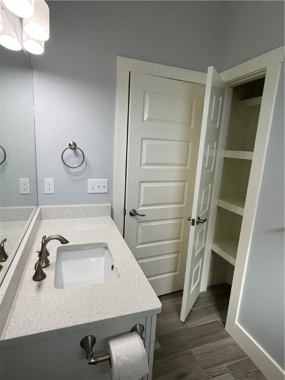 bathroom with hardwood / wood-style flooring and vanity