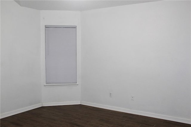 spare room featuring dark wood-type flooring