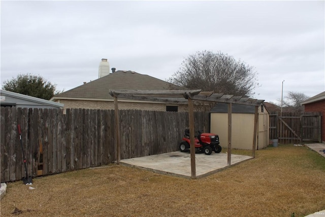 view of yard with a shed and a patio area