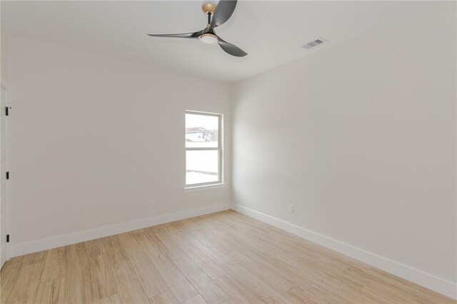 spare room with light hardwood / wood-style flooring and ceiling fan