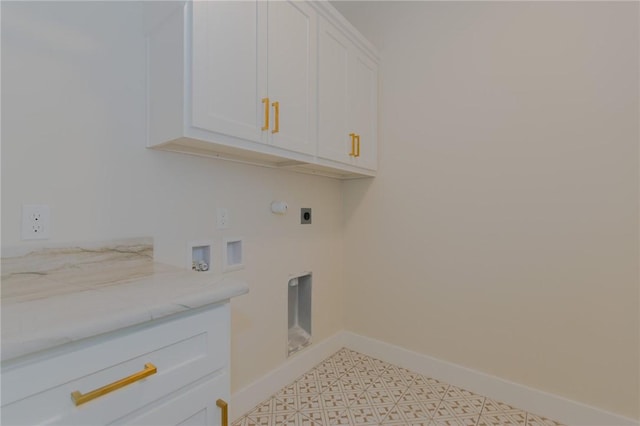 clothes washing area featuring cabinets, hookup for an electric dryer, and hookup for a washing machine