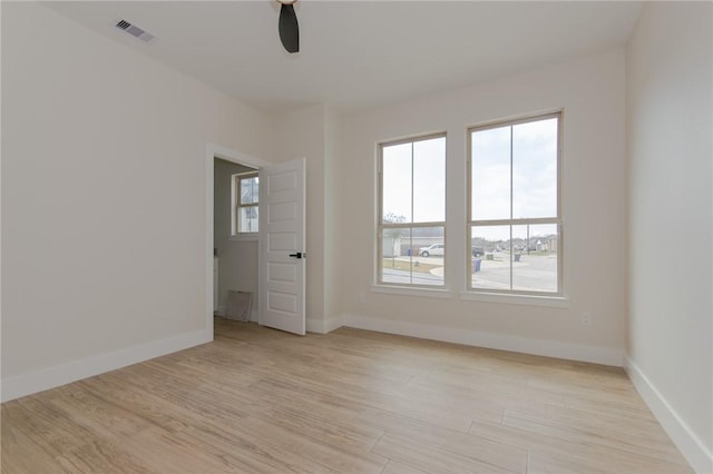 unfurnished room featuring ceiling fan and light wood-type flooring