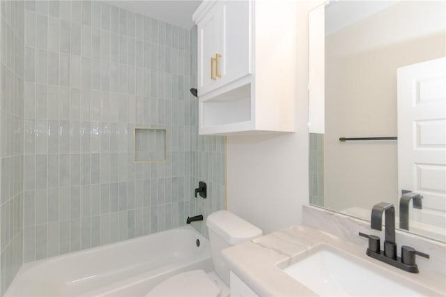 full bathroom with tiled shower / bath combo, vanity, and toilet