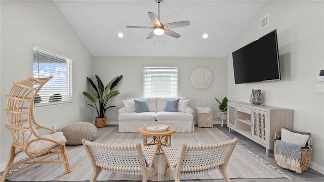 living room featuring ceiling fan, plenty of natural light, and vaulted ceiling