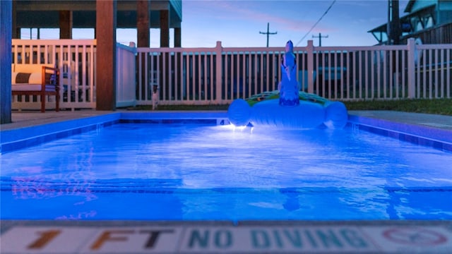 view of pool at dusk