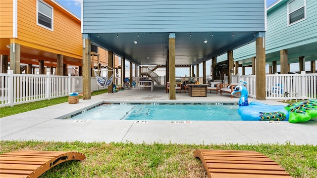 view of pool with a patio and an outdoor living space