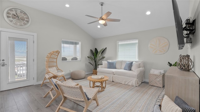 living room featuring light wood-type flooring, lofted ceiling, and ceiling fan