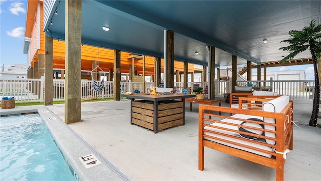 view of patio / terrace featuring a fire pit and a swimming pool