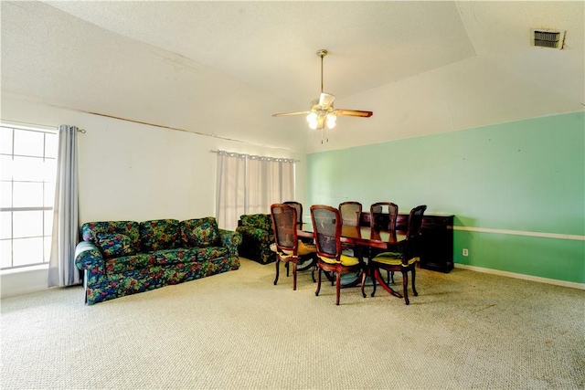 dining room with carpet floors, visible vents, baseboards, vaulted ceiling, and a ceiling fan