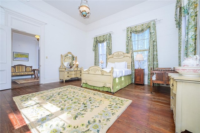 bedroom with dark wood-type flooring