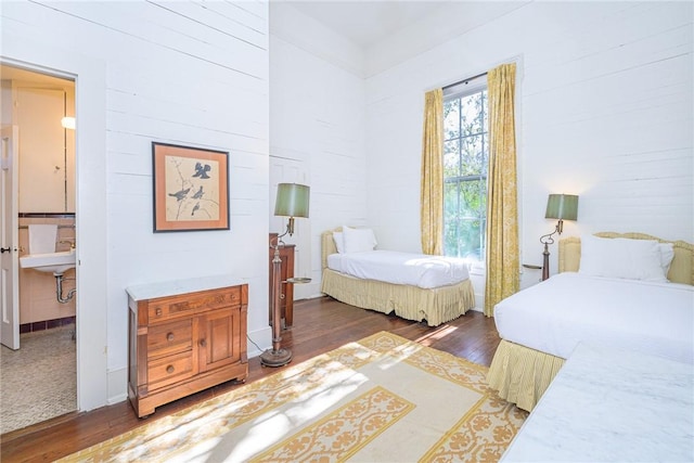 bedroom with dark hardwood / wood-style floors