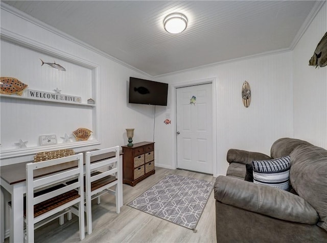 living room with crown molding and light hardwood / wood-style floors