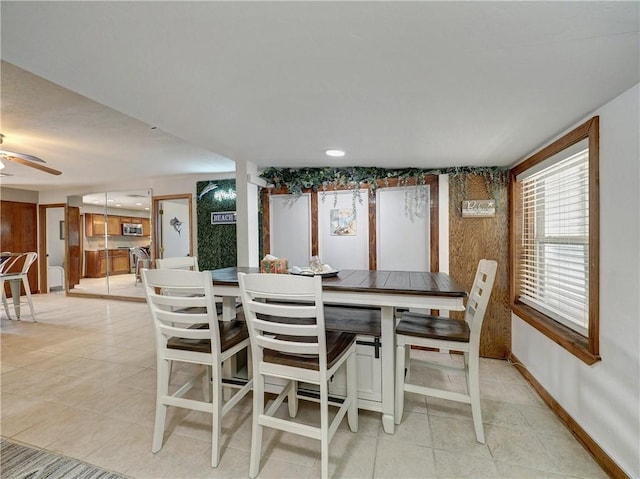 dining area with light tile patterned flooring and ceiling fan