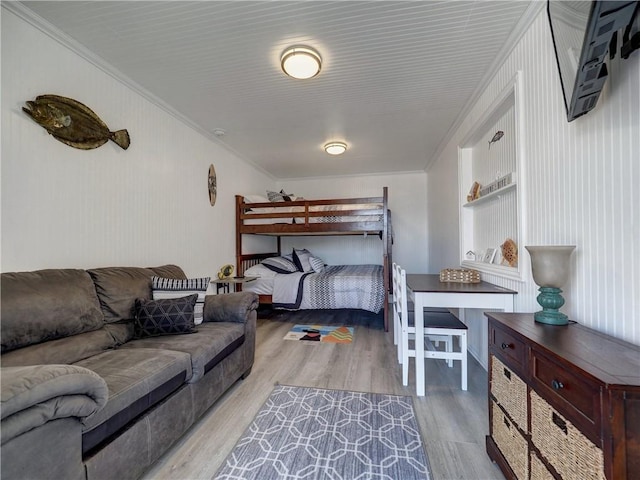 bedroom with light hardwood / wood-style flooring and ornamental molding