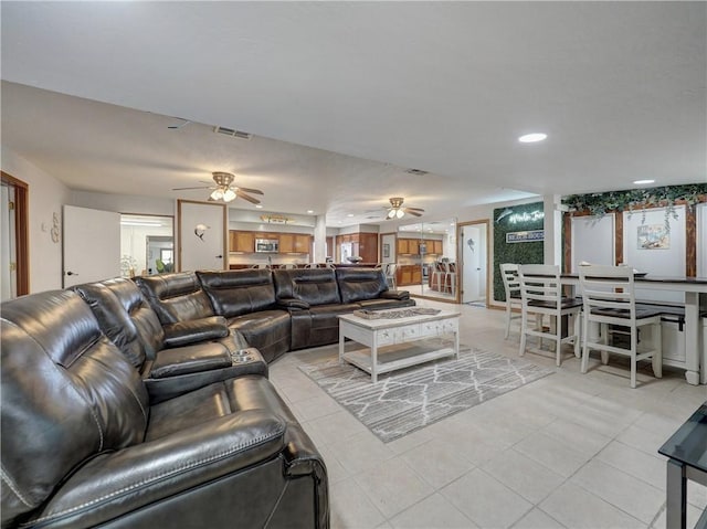 tiled living room with ceiling fan