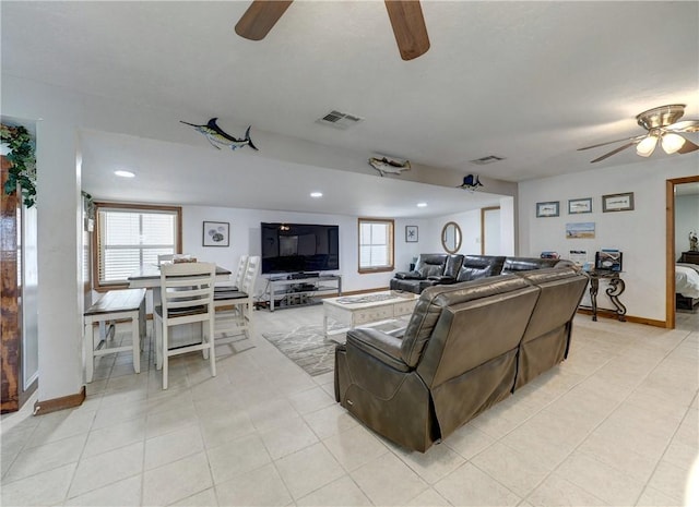 tiled living room with ceiling fan and a healthy amount of sunlight