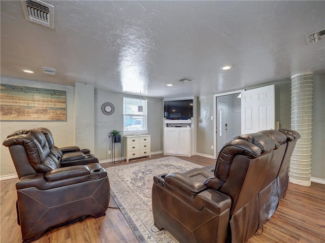 living room with wood-type flooring and a textured ceiling