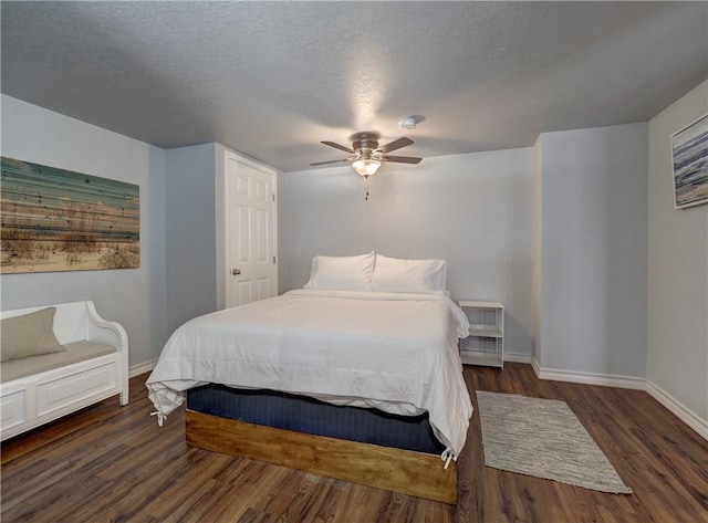 bedroom featuring ceiling fan, dark hardwood / wood-style floors, and a textured ceiling