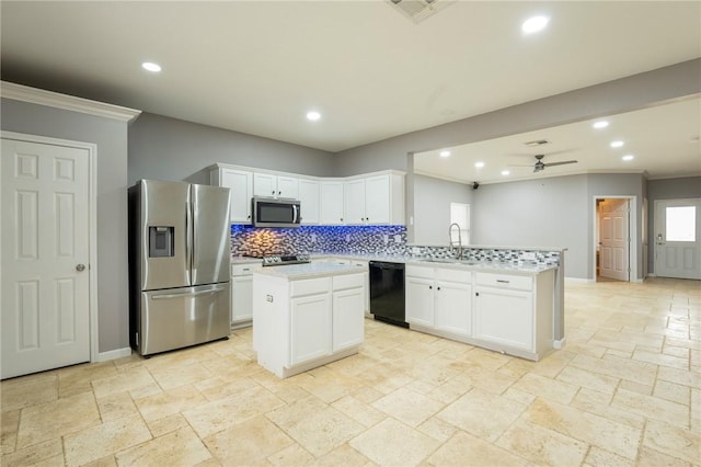 kitchen featuring sink, a center island, white cabinets, and appliances with stainless steel finishes