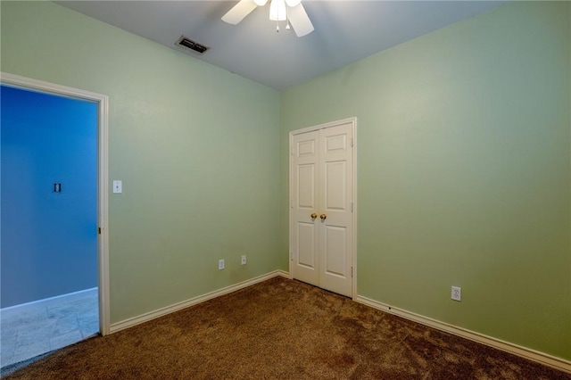 spare room featuring carpet floors and ceiling fan