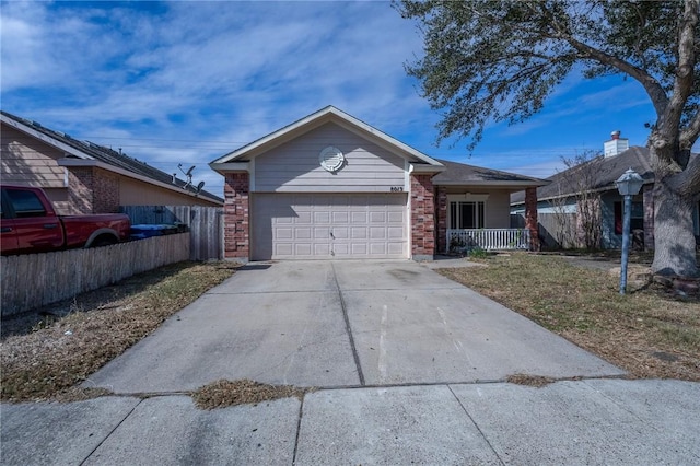 single story home featuring brick siding, covered porch, an attached garage, fence, and driveway