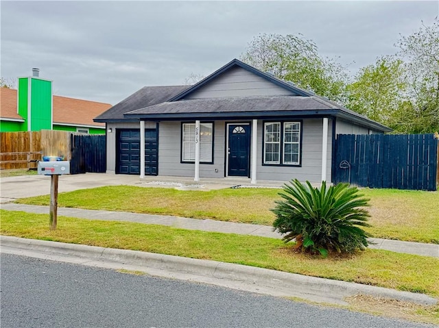 view of front of property with a front lawn and a garage