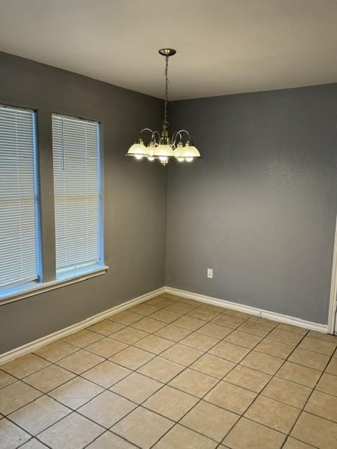 unfurnished dining area featuring a notable chandelier and light tile patterned flooring