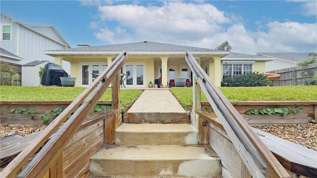 exterior space with french doors and a front yard