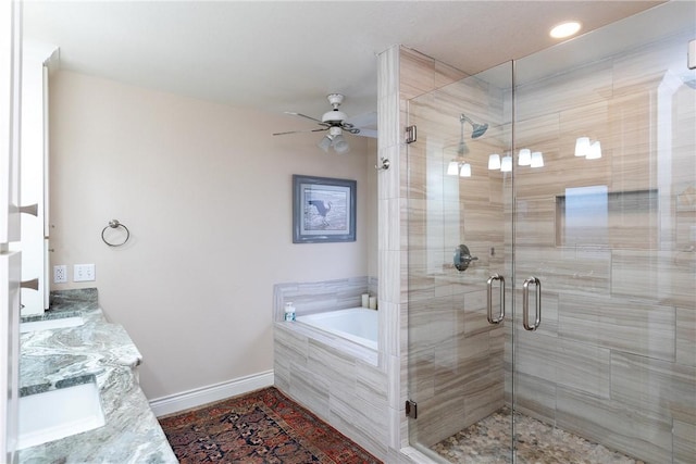 bathroom featuring independent shower and bath, vanity, and ceiling fan