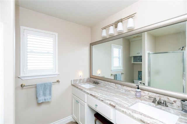 bathroom featuring walk in shower and vanity