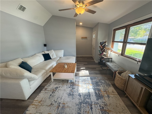 living room featuring ceiling fan, dark wood-type flooring, and lofted ceiling