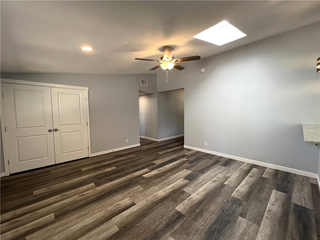 unfurnished bedroom featuring a closet, ceiling fan, dark hardwood / wood-style flooring, and lofted ceiling