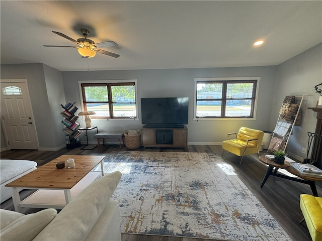 living room featuring dark hardwood / wood-style floors and ceiling fan