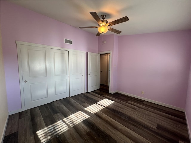 unfurnished bedroom featuring a closet, ceiling fan, and dark wood-type flooring