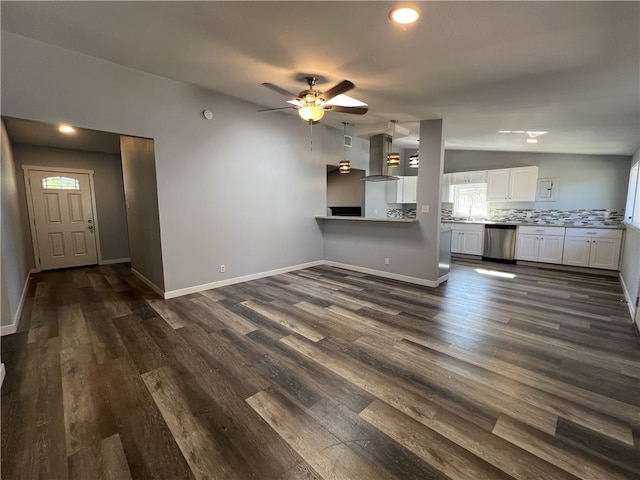 unfurnished living room with ceiling fan, dark hardwood / wood-style flooring, and lofted ceiling