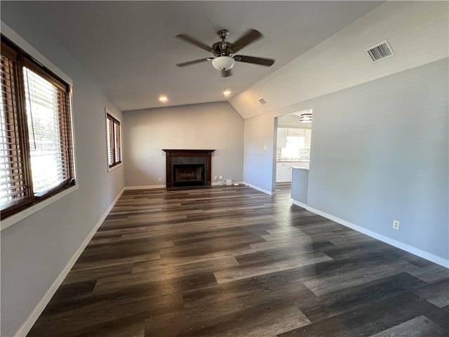 unfurnished living room with vaulted ceiling, ceiling fan, and dark wood-type flooring