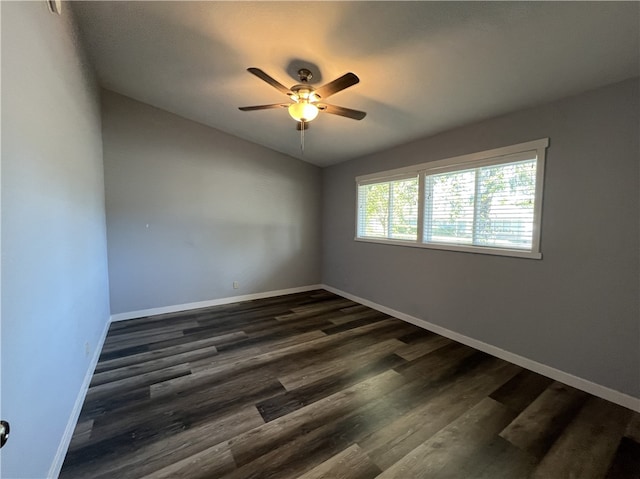 unfurnished room featuring ceiling fan and dark wood-type flooring