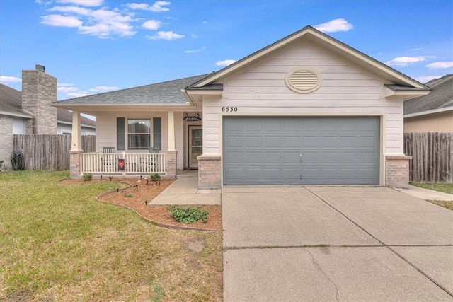 single story home featuring a garage, covered porch, and a front lawn