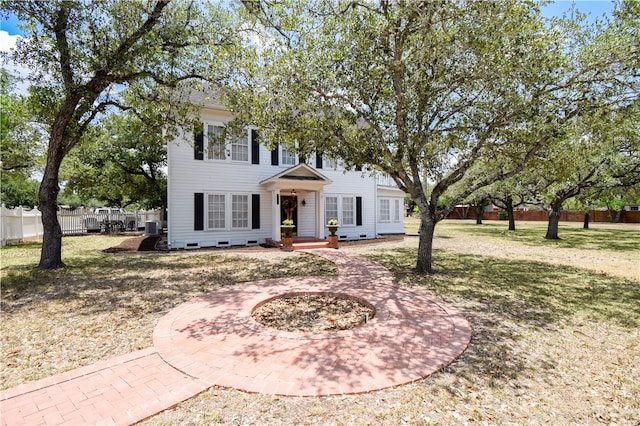 view of front of home featuring central AC and a front yard