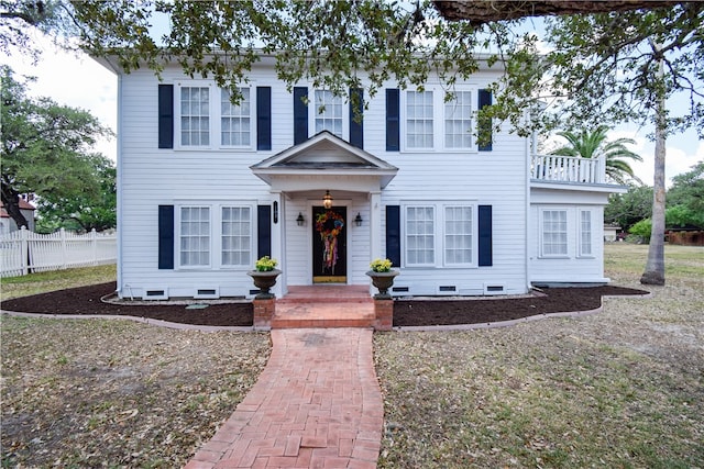 colonial inspired home with a balcony