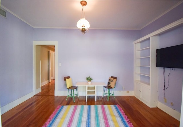 203 S Bowie St, Sinton, TX 78387 - living area featuring wood finished floors, crown molding, and baseboards