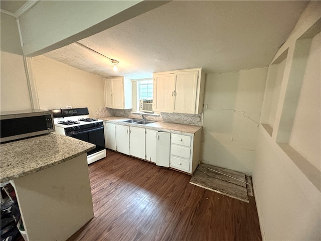 kitchen featuring white cabinetry, sink, dark hardwood / wood-style floors, a textured ceiling, and white appliances