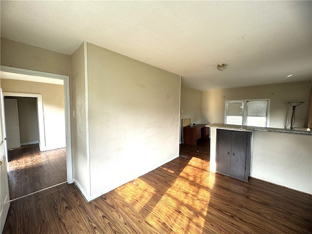 empty room with dark hardwood / wood-style flooring