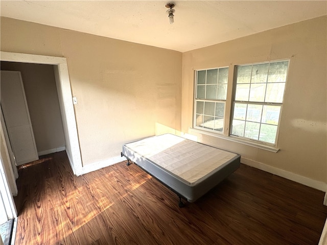 unfurnished bedroom featuring dark wood-type flooring