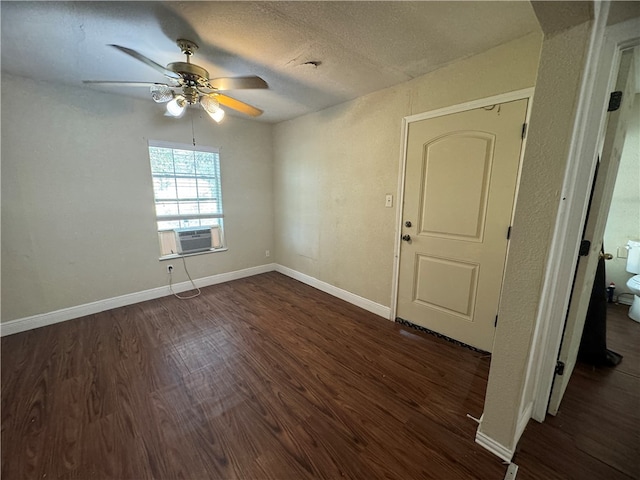 spare room with dark wood-type flooring, ceiling fan, a textured ceiling, and cooling unit