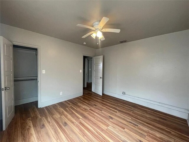 2129 16th St, Corpus Christi, TX 78404 - unfurnished bedroom with wood finished floors, a closet, visible vents, baseboards, and ceiling fan