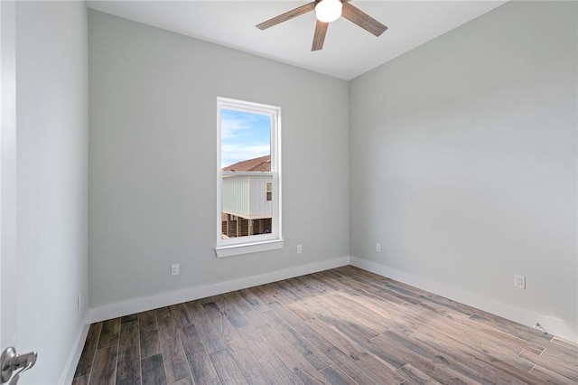 1007 S Live Oak St, Rockport, TX 78382 - unfurnished room with a ceiling fan, wood finished floors, and baseboards