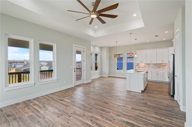 1007 S Live Oak St, Rockport, TX 78382 - kitchen with freestanding refrigerator, a sink, a ceiling fan, open floor plan, and a raised ceiling